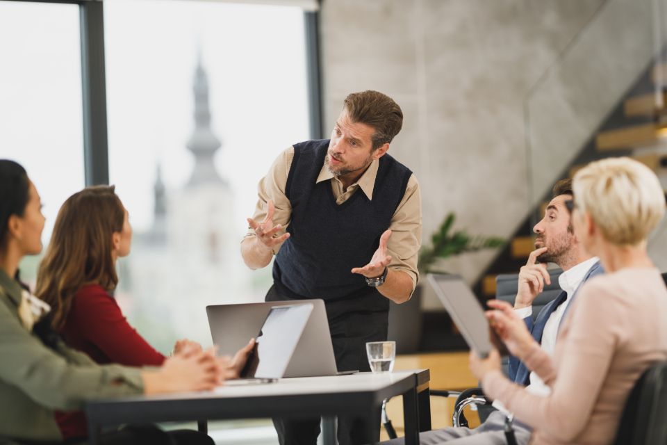 Een groep mensen werkt samen aan tafel en overlegt